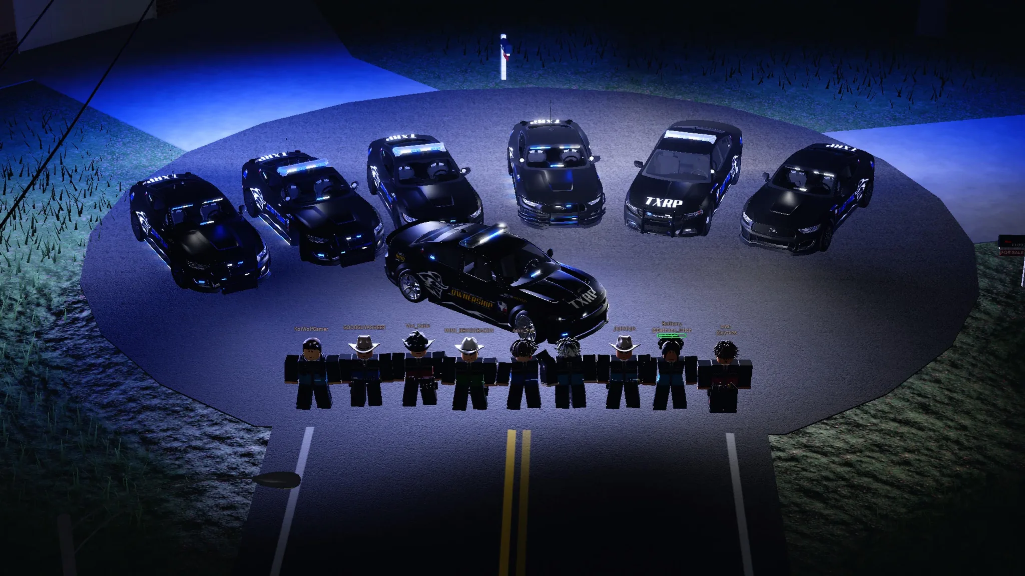 The TXRP fleet lined up at night with staff standing in front